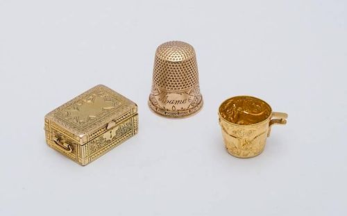 SILVER-GILT PILL BOX IN THE FORM OF A WRITING BOX, A MINIATURE GILT CUP AND A GOLD THIMBLE