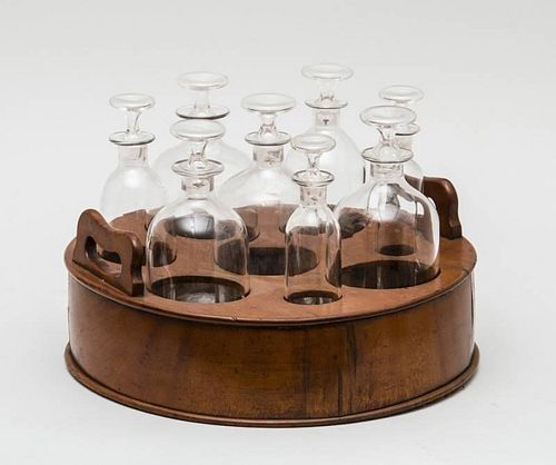 ENGLISH MAHOGANY TWO-HANDLED BOTTLE CADDY FITTED WITH EIGHT CLEAR GLASS DECANTERS AND STOPPERS