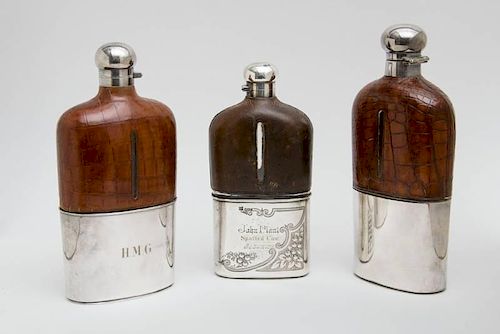 TWO SIMILAR ENGLISH ALLIGATOR SKIN-CLAD AND SILVER-PLATE MOUNTED FLASKS AND A LEATHER-CLAD FLASK