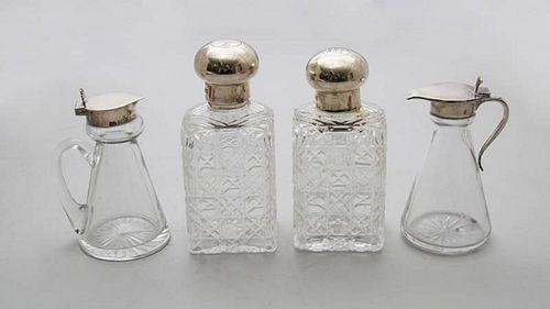 PAIR OF ENGLISH MONOGRAMMED SILVER-LIDDED CUT-GLASS SCENT BOTTLES AND TWO ENGLISH SILVER LIDDED GLASS CRUETS