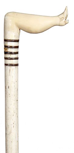 4. Naughty Leg Whale Bone cane - mid 19th C. – A carved whale’s tooth leg which has scrimshaw work to designate the shoe, The nerve ending hole for th