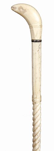 6. Whale’s Tooth and Bone cane - mid 19th C. – a carved whale’s tooth handle and baleen spacers, ¾” shaft which is reeded for 4 ½” then spiral carved 