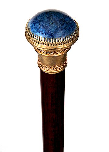 74. Lapis Dress Cane- Ca. 1880- 1 ¼” lapis stone is inlaid atop an ornate gilt mounting, probably Vienna but the hallmarks are unreadable, snakewood s
