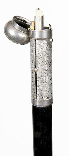 84. Push-up Candle Cane- Late 19th Century- A German nickel plated brass handle which contains a compartment for matches and a push-up candle, “Nordde