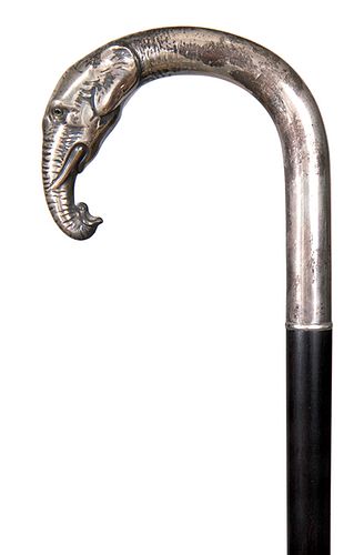 85. Sterling Elephant Cane- Early 20th Century- A fine cast sterling elephant with two color glass eyes, in perfect condition, ebony shaft and a horn 