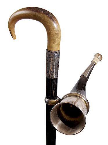 94. Ear Trumpet Cane- Early 20th Century- An unusual hearing aid system cane with a horn handle, ornate silver collar which in inscribed “presented to
