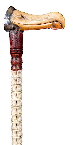 104. Albatross Nautical Cane- Ca. 1870- A scarce marine cane fashioned with a hinged silver mounted bill, this cane was probably used as a glove holde