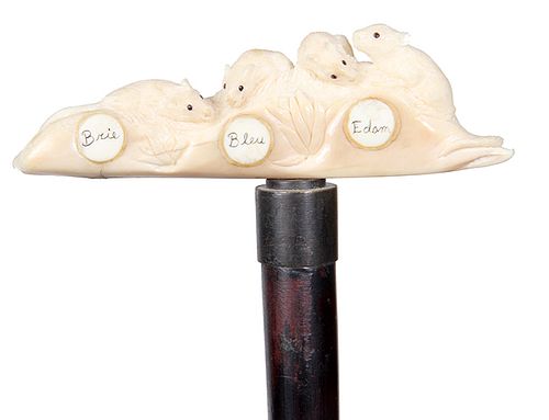 131. Mammoth Ivory Cheese Cane- Ca. 1890- A whimsical carving of four mice with black beaded eyes peering at small blocks of a variety of cheeses, bot