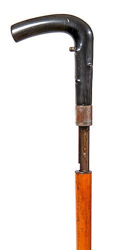168. Breech Loading Gun Cane- Ca. 1875- A twigspur horn handle, the malacca shaft releases from the brass collar for loading, fine working condition w