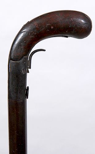 175. Under Hammer Gun Cane- Ca. 1840- A muzzle loading, working under hammer gun cane, approximately 38.40 caliber, barrel has two sights, wood handle