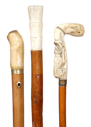 186. Group of Three Bone and Stag Canes- An L-handle bone cane with a sleeping hound dog, a bone handle with carved alligator and fish and a stag hand