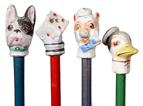188. Collection of Carnival Canes- Four porcelain carnival canes with original painted shafts in fine condition including the hard to find “Rogue Dona