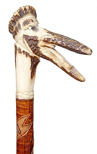 190. German Folk Cane- Dated 1900- A red deer antler of an “alligator” type man with two color glass eyes, hardwood shaft with natural bark and a meta