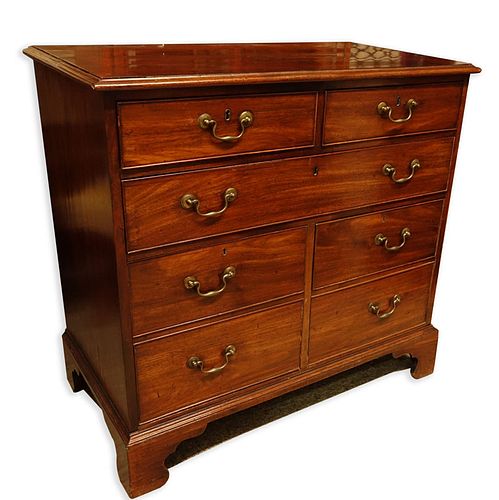 Antique Georgian Mahogany Chest of Drawers. Large fitted center drawer, two deep drawers lower, two fitted drawers with brass pulls, raised on shaped 