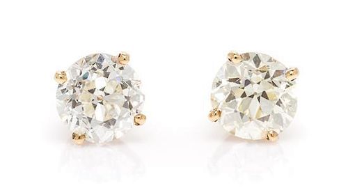 A Pair of 14 Karat Yellow Gold and Diamond Stud Earrings, 1.10 dwts.