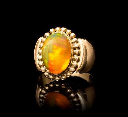 An 18 Karat Yellow Gold and Fire Opal Ring, 6.60 dwts.