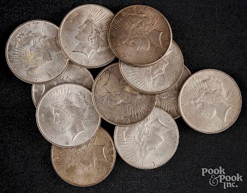 Eleven Peace silver dollars.