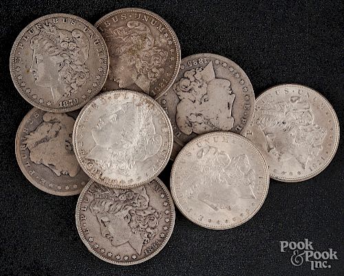 Nine Morgan silver dollars.
