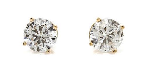 A Pair of 14 Karat Yellow Gold and Diamond Stud Earrings, 0.70 dwts.