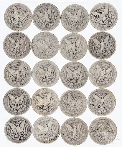 Twenty Morgan silver dollars.