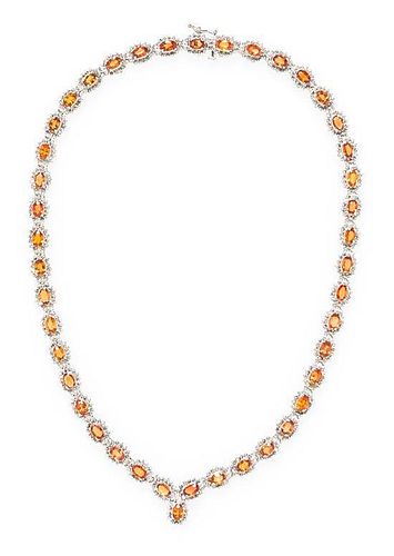 A 14 Karat White Gold, Orange Sapphire and Diamond Necklace, 25.50 dwts.