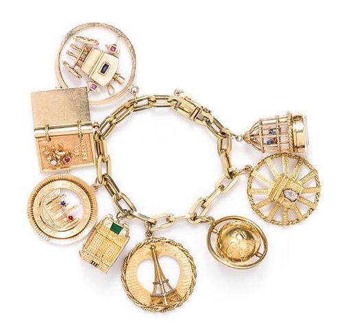 A Yellow Gold Multi Gem Charm Bracelet with Eight Attached Charms, 66.00 dwts.