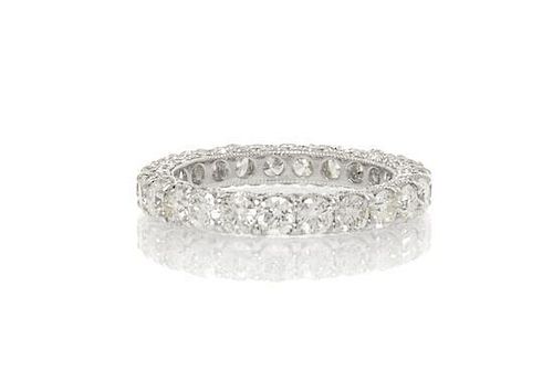 An 18 Karat White Gold and Diamond Eternity Band Ring, 1.90 dwts.