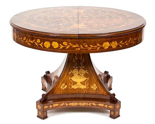 A Dutch Mahogany and Fruitwood Marquetry Center Table Height 31 1/2 x diameter 41 1/2 inches.