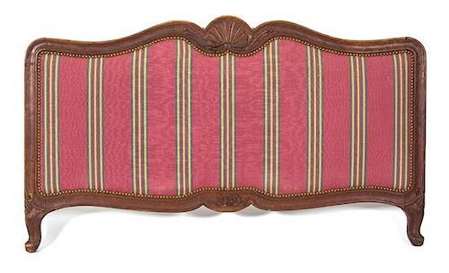 A Louis XV Style Carved Walnut and Upholstered Headboard and Footboard 