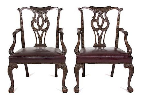 A Pair of George II Style Carved Mahogany Open Armchairs Height 38 inches.