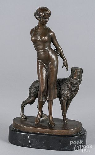 Patinated bronze of a woman and dog