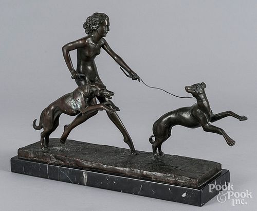 Patinated bronze of a woman with dogs