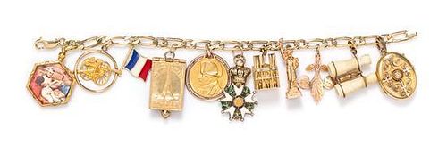 * A Yellow Gold and Goldtone Charm Bracelet with 11 Attached Charms, 33.80 dwts.