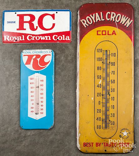 Two advertising thermometers and a sign