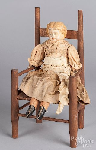 Antique composition doll and doll chair.