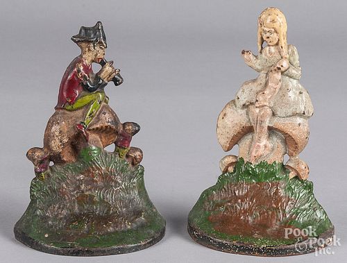 Two painted cast iron doorstops