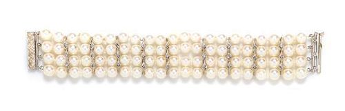 A 14 Karat White Gold, Diamond and Cultured Pearl Bracelet, 29.90 dwts.