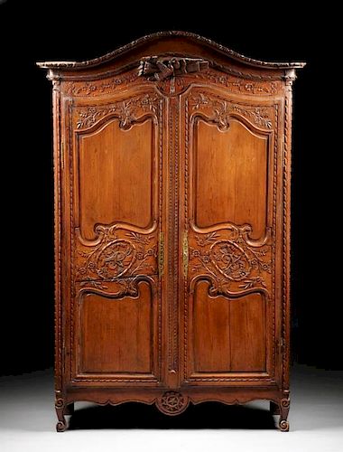 A FRENCH PROVINCIAL CARVED WAXED PINE ARMOIRE, FIRST HALF 19TH CENTURY,