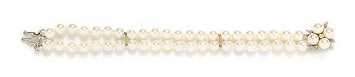 * A 14 Karat White Gold, Diamond and Cultured Pearl Double Strand Bracelet,