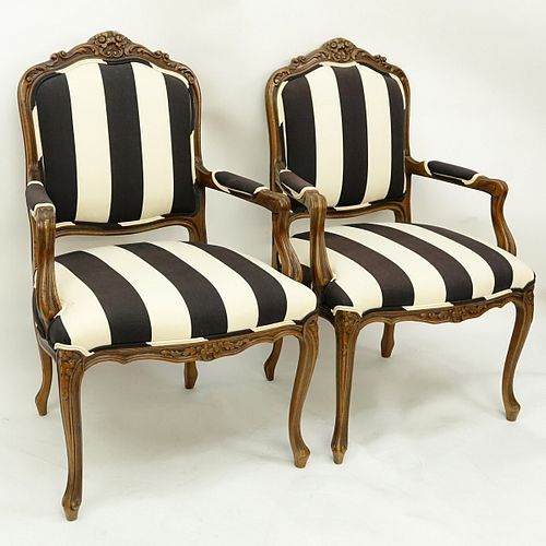 Pair of 20th Century Carved Wood and Upholstered Fauteuils. Light scratches to wood.