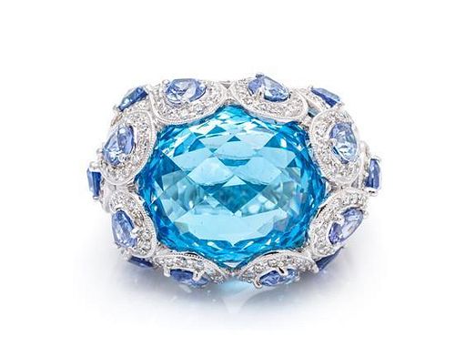 An 18 Karat White Gold, Blue Topaz, Sapphire and Diamond Ring, 13.40 dwts.