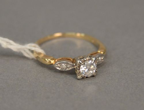 14 karat yellow gold antique setting with .25 carats (gauged in setting) round diamond set in white gold four prong head, with one r...