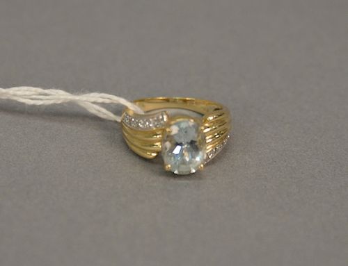 14 karat yellow gold setting with oval aquamarine 9.9 x 8mm, has a single row on each side of five round diamonds that meets on oppo...