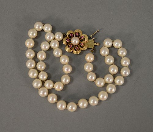 Pearl Necklace with 14 karat gold flower clasp.