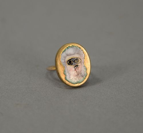 18 karat gold and enameled opera ring having an enameled bust of a woman.