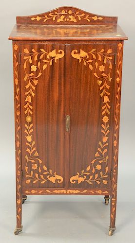Victorian mahogany inlaid music stand with two doors open to fitted drawers plaque "patented 1887". ht. 43 1/2in., wd. 21 1/4in.
