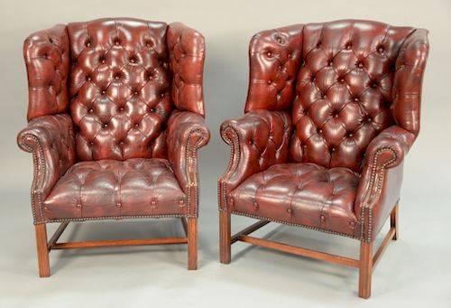 Pair of tufted leather Chippendale style wing chairs. ht. 41in.