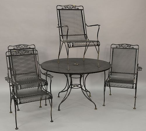 Six piece outdoor iron set to include a round table with mesh top, four matching armchairs, and one small table (ht. 28in., dia. 47i...