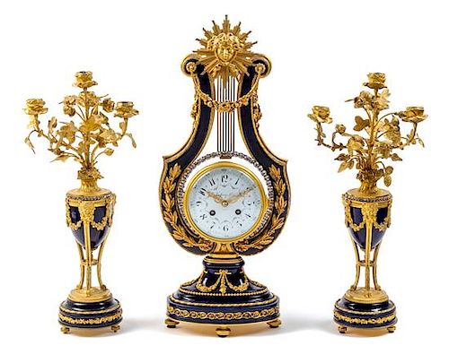A French Gilt Bronze and Porcelain Clock Garniture Height of mantel clock 22 1/2 inches.