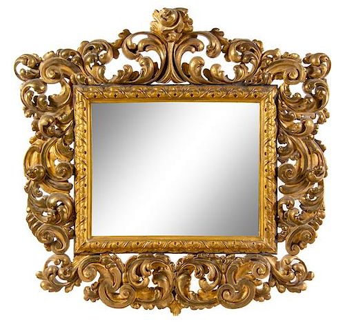 * An Italian Baroque Style Giltwood Mirror Height 51 x width 52 inches.